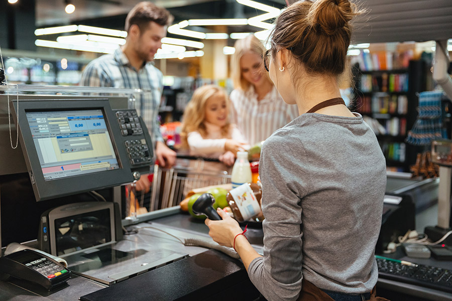 Family checking at grocery store.